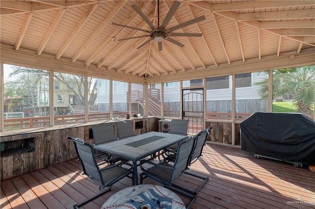 sunroom featuring vaulted ceiling with beams, ceiling fan, a healthy amount of sunlight, and wooden ceiling