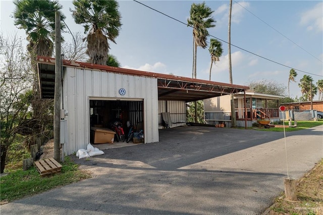 view of parking / parking lot with a garage