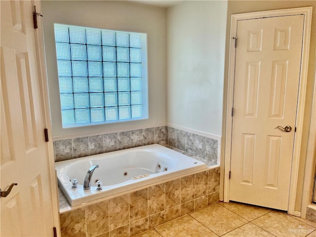 bathroom with tile patterned flooring and a jetted tub