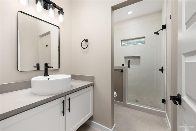 bathroom featuring walk in shower, vanity, and toilet