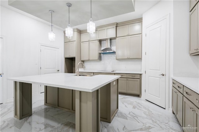 303 N 31st St, Hidalgo, TX 78557 - kitchen with wall chimney range hood, light marble finish floors, tasteful backsplash, an island with sink, and electric cooktop
