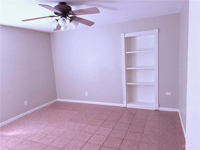 empty room featuring ceiling fan and built in features