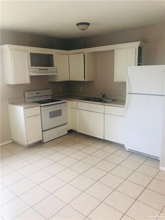 kitchen with light tile patterned flooring, white appliances, and sink