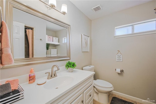 full bathroom featuring toilet, vanity, tile patterned floors, and baseboards