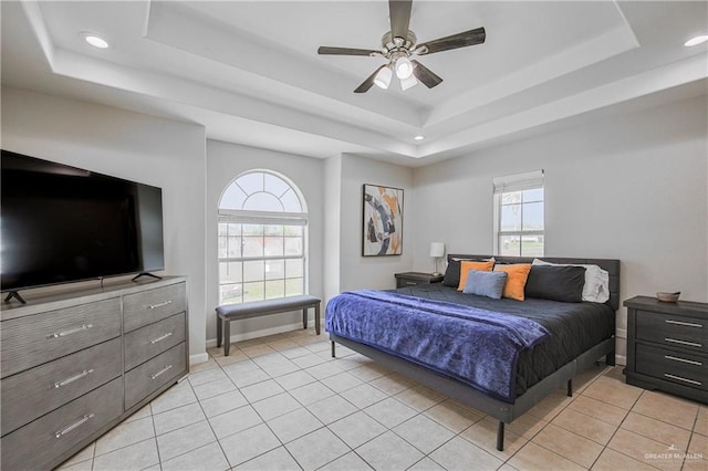 bedroom featuring a raised ceiling, multiple windows, recessed lighting, and light tile patterned floors