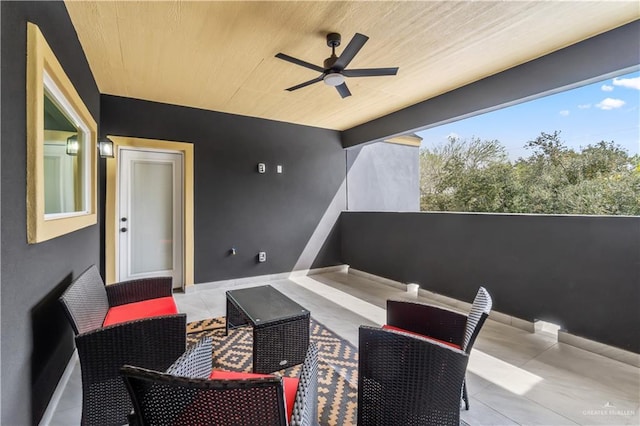 view of patio / terrace with ceiling fan and a balcony