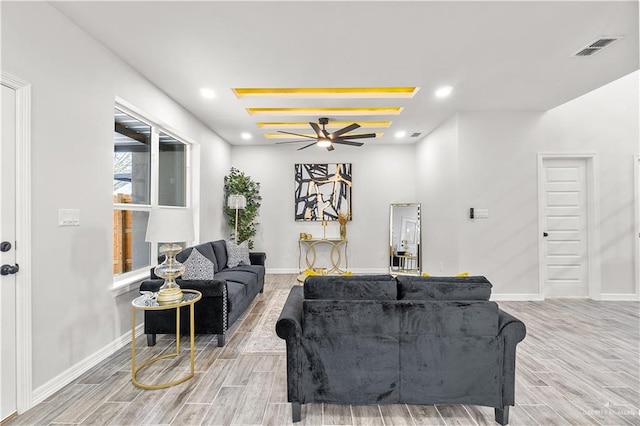 living area featuring light wood-style floors, baseboards, visible vents, and recessed lighting