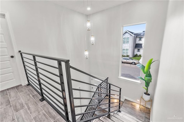 stairway with wood finish floors and baseboards