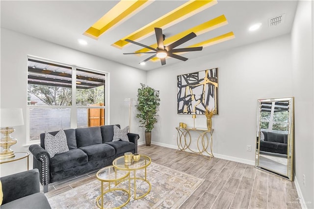 living area with recessed lighting, baseboards, visible vents, and wood finish floors