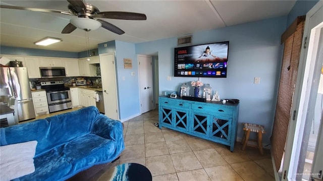 tiled living room with ceiling fan