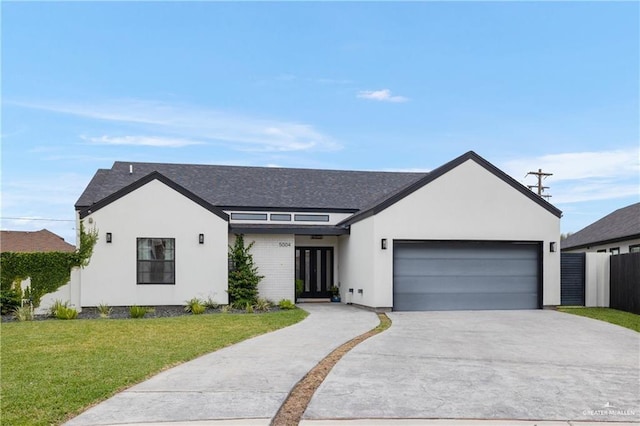 view of front of house featuring a garage and a front yard