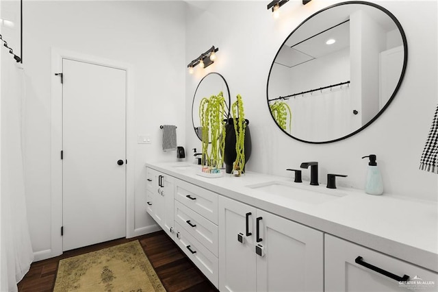 bathroom with vanity, hardwood / wood-style flooring, and walk in shower