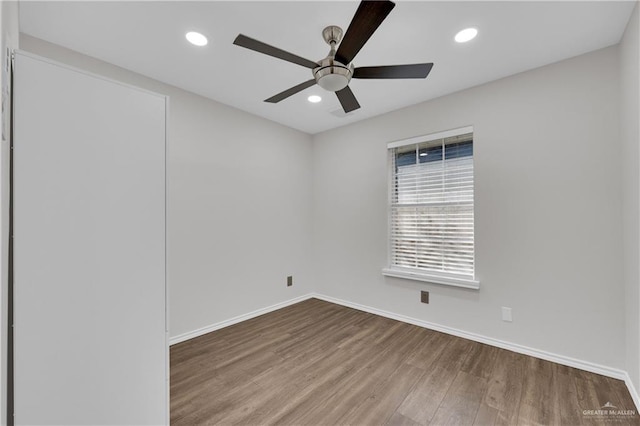 empty room featuring wood-type flooring and ceiling fan