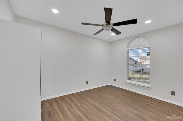 spare room featuring wood-type flooring and ceiling fan