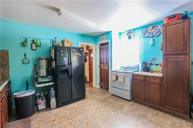 kitchen with a textured ceiling, black fridge with ice dispenser, and electric range
