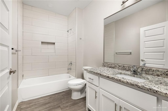 full bathroom with toilet, vanity,  shower combination, and wood finished floors