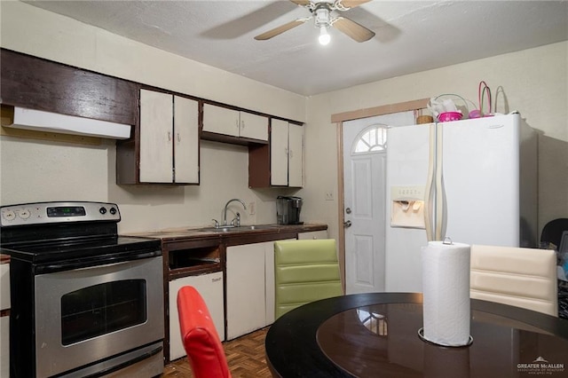 kitchen with a sink, ceiling fan, white refrigerator with ice dispenser, and electric stove