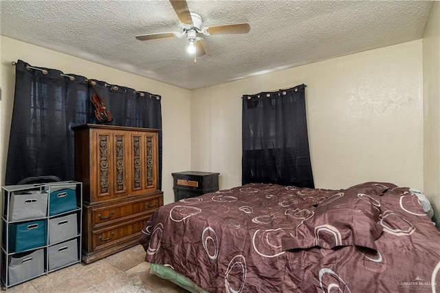 bedroom with a textured ceiling and a ceiling fan