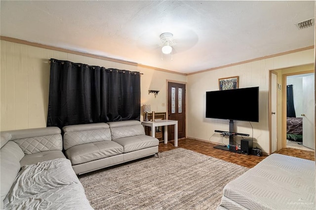 living room featuring visible vents and crown molding