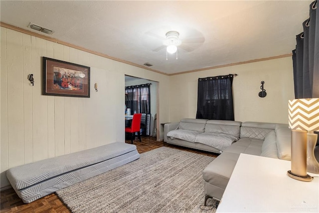 living area featuring visible vents and crown molding