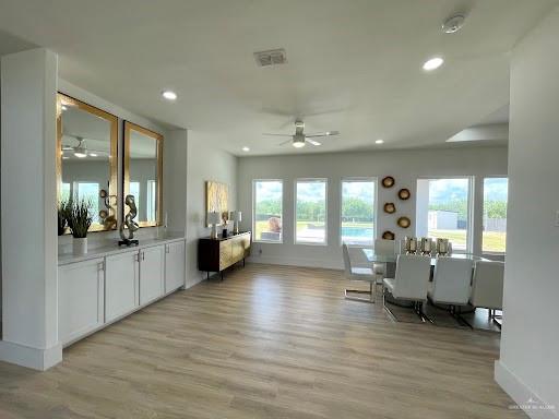 sitting room featuring light wood-style floors, baseboards, visible vents, and recessed lighting