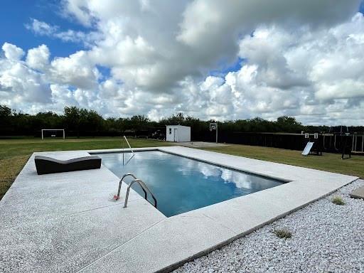 view of swimming pool with a yard, playground community, and a patio area