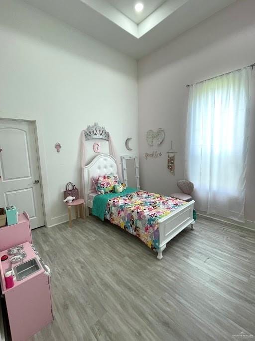 bedroom featuring baseboards and wood finished floors