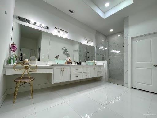 full bath with tile patterned floors, visible vents, a marble finish shower, and double vanity