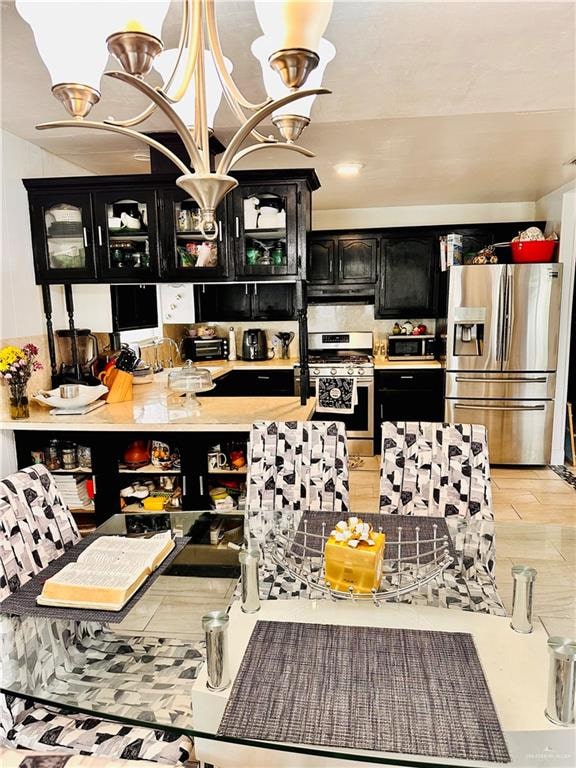 kitchen with a chandelier and appliances with stainless steel finishes