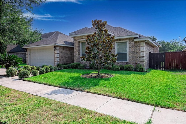 view of front of property with a front lawn and a garage