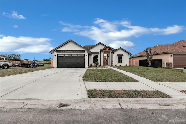 view of front of property with a garage and a front lawn