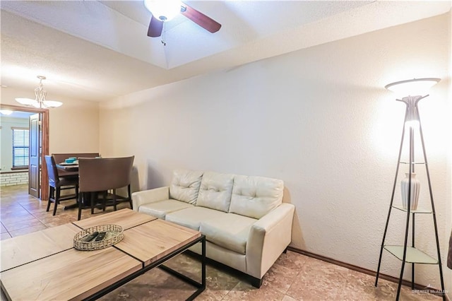 living room with ceiling fan and light tile patterned flooring