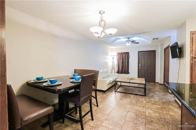 dining area with ceiling fan with notable chandelier