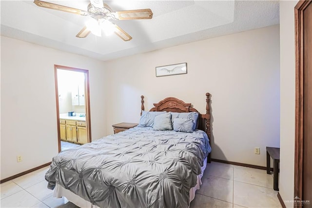 tiled bedroom with ceiling fan, a textured ceiling, and connected bathroom