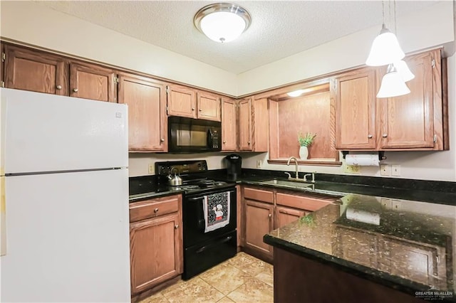 kitchen featuring dark stone counters, black appliances, sink, hanging light fixtures, and a textured ceiling