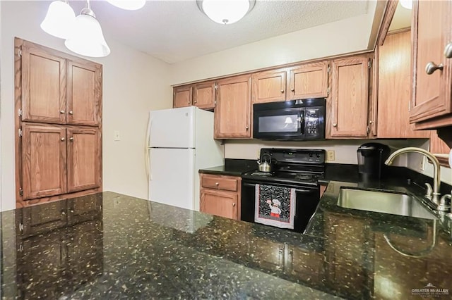 kitchen with sink, dark stone counters, pendant lighting, a textured ceiling, and black appliances