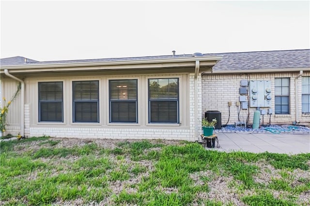 rear view of property with cooling unit and a yard