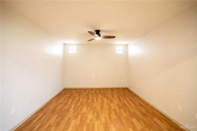 empty room with ceiling fan and light wood-type flooring