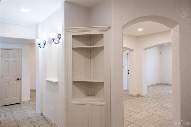 corridor with light tile patterned floors