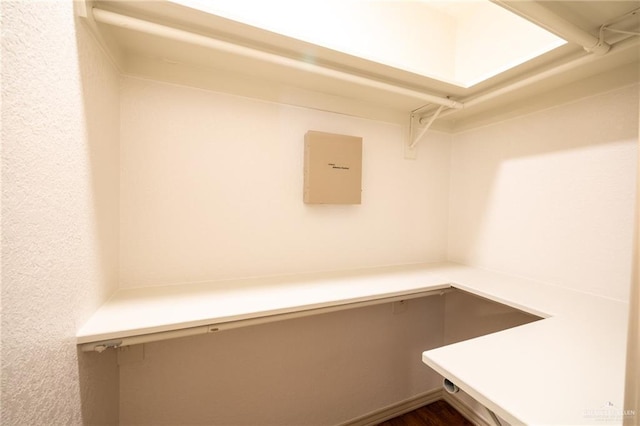 spacious closet featuring dark hardwood / wood-style flooring