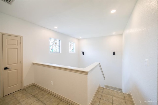 corridor with light tile patterned floors