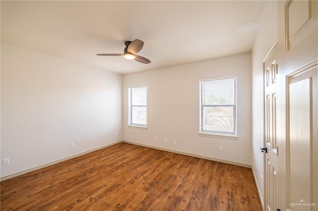 unfurnished room with ceiling fan, a healthy amount of sunlight, and hardwood / wood-style flooring