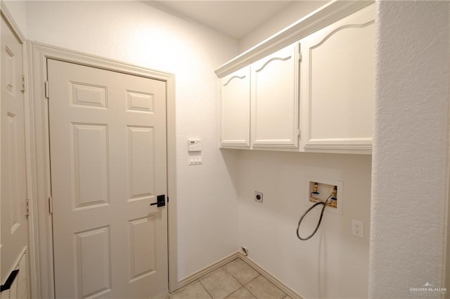 laundry room featuring electric dryer hookup, light tile patterned flooring, cabinets, and hookup for a washing machine