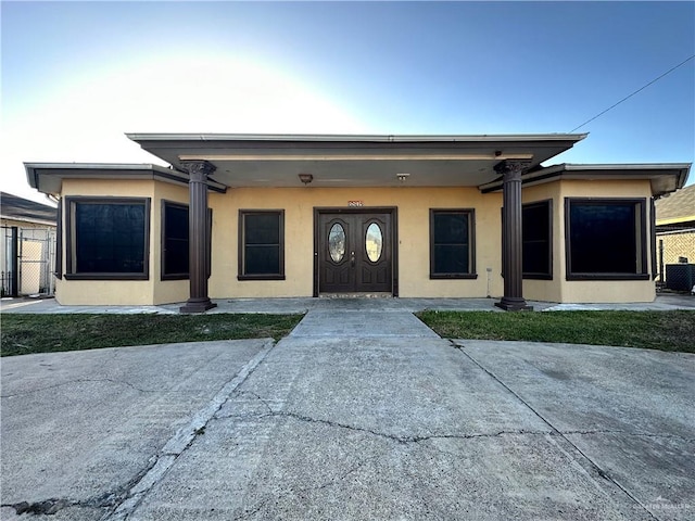 view of front of property with fence and stucco siding