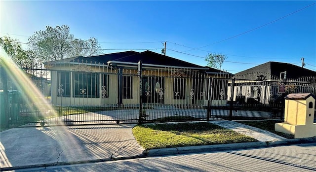 view of front of house featuring a fenced front yard and a gate