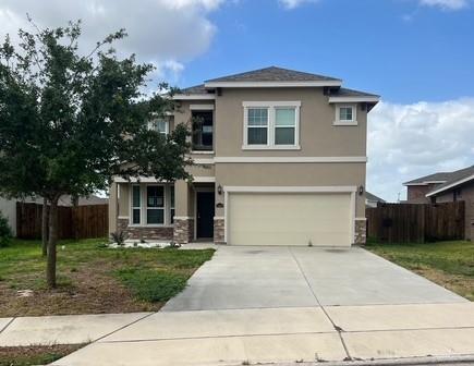 14405 Chalk Ridge Dr, Mcallen, TX 78504 - view of front of home with stucco siding, stone siding, driveway, and a garage