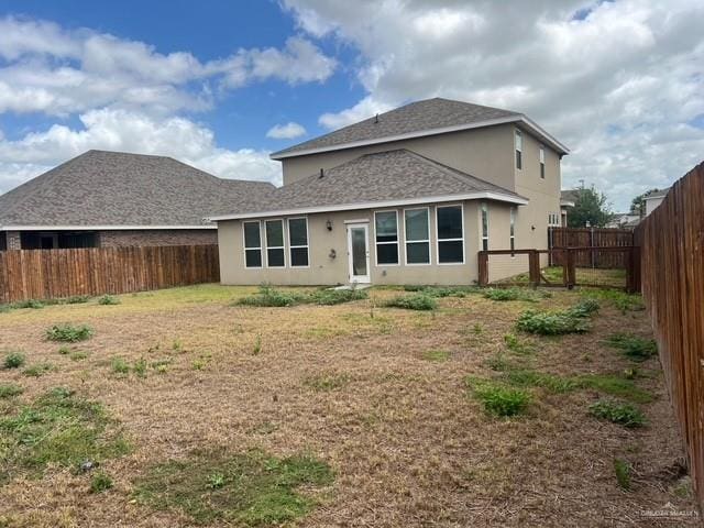 14405 Chalk Ridge Dr, Mcallen, TX 78504 - rear view of house featuring stucco siding, a fenced backyard, and a shingled roof