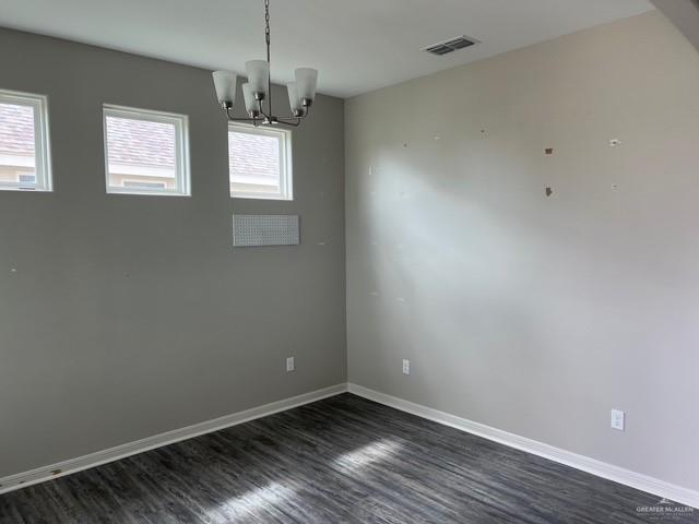 14405 Chalk Ridge Dr, Mcallen, TX 78504 - unfurnished room featuring dark wood finished floors and a chandelier
