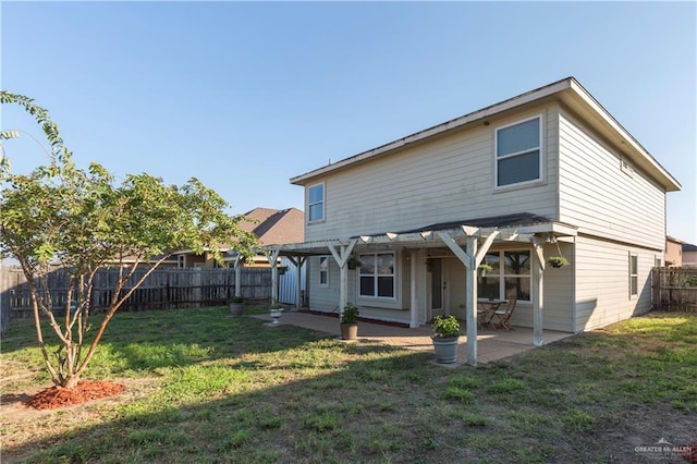 back of house featuring a pergola, a patio, and a lawn