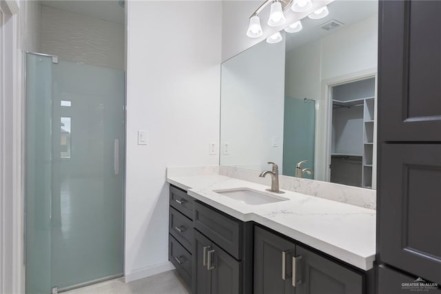 bathroom featuring a shower and vanity